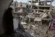 Palestinians inspect the rubble of the Ismail family home, destroyed in Israeli airstrike at Al-Maghazi camp, in the central Gaza Strip, May 21, 2026