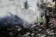 Palestinians walk through the rubble of the Al-Kurd family home, destroyed in an Israeli airstrike in Deir al-Balah, central Gaza Strip, May 24, 2026