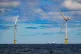 A ship passing wind turbines at RWE's Gwynt y Mor, the world's 2nd largest offshore wind farm located eight miles offshore in Liverpool Bay, off the coast of North Wales