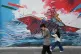 People walk past a mural depicting a U.S. aircraft carrier under missile attack in downtown Tehran, Iran, May 17, 2026
