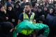 A Lebanese Civil Defense member carries the body of 6-month-old Mariam Fahos, killed a day earlier in an Israeli airstrike in the village of Saksakieh, as women grieve during a funeral procession in the southern port city of Sidon, Lebanon, May 10, 2026