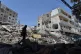 A man walks next to buildings destroyed in Israeli airstrikes the previous day in the southern village of Maarakeh, Lebanon, May 17, 2026