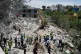 Rescue workers search for victims in the rubble of a destroyed house that was hit on Tuesday by an Israeli airstrike, in the village of Deir Qanoun al Nahr, south Lebanon, May 20, 2026
