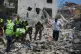 Rescue workers search for victims in the rubble of a destroyed house that was hit on Tuesday by an Israeli airstrike, in the village of Deir Qanoun al Nahr, south Lebanon, May 20, 2026