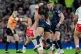 Hull KR's Tyrone May (centre) is tackled by Wigan Warriors' Brad O'Neill (left) and Wigan Warriors' Liam Byrne (right) during the Betfred Super League Grand Final at Old Trafford, Manchester, October 11, 2025