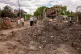 Local residents look at a large crater and heavily damaged residential houses following an overnight Russian air attack in Kyiv, Ukraine, June 15, 2026