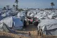 Palestinian children walk between tents at an orphanage camp in Khan Younis, southern Gaza Strip, January 20, 2026
