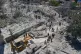 Rescue workers and people search for victims at destroyed building that was hit in an Israeli airstrike in Qannarit village, southern Lebanon, Saturday, June 20, 2026