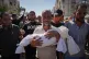 Thaer Abu Daraz carries the body of his infant daughter, Sewar, who was killed along with her mother in an Israeli airstrike that struck a tent camp for displaced Palestinians in Khan Younis, Gaza Strip, Tuesday, June 30, 2026