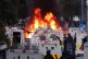 Protesters set fire to a barricade as police block Antrim Road, at the Sandyknowes roundabout in Newtownabbey, June 10, 2026
