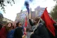 A demonstrator releases a smoke flare in front of a mural on Cable Street in the East End of London, October 9, 2016