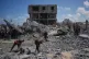Palestinians inspect the rubble of a building destroyed in an Israeli airstrike at Khan Younis, in the southern Gaza Strip, June 7, 2026