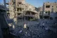 Palestinians inspect buildings that were destroyed in an Israeli airstrike, at al-Maghazi refugee camp, central Gaza Strip, June 12, 2026
