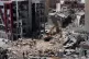 Rescue workers use an excavator, as they search for victims under the rubble of a building that was hit Monday in an Israeli airstrike in the southern port city of Tyre, Lebanon, June 2, 2026