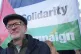 Jeremy Corbyn in front of a Palestine flag