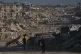 Palestinians walk along a road surrounded by buildings destroyed in Israeli military strikes during the Israel-Hamas war, in Jabaliya, Gaza Strip, July 2, 2026