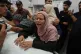 Roaa Abu Jarad mourns over the body of her father Omran Abu Jarad, 48, who was killed in an Israeli military strike, during his funeral at Al-Shifa Hospital in Gaza City, July 7, 2026