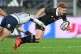 New Zealand's Damian McKenzie is tackled during the Nations Championship rugby international between the All Blacks and Italy in Wellington, New Zealand, Saturday July 11