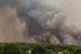 Smoke rises as a water bomber flies over wildfires in the Lege-Cap-Ferret region, western France, July 23, 2026