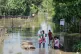Flood affected villagers wait to cross the flood water in Sivsager, upper Assam, India, July 24, 2026