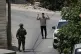 An Israeli soldier interrogates a Palestinian resident during an army operation in the West Bank village of Tell, near Nablus, July 25, 2026
