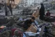 Palestinians salvage their belongings from the rubble of a building and tents destroyed in an Israeli airstrike in Gaza City, July 30, 2026