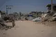 A Palestinian walks through the devastation of Gaza