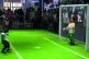 A boy plays football with a robot at the conference in Beijing