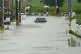 A vehicle is left in a street flooded due to a heavy rain in Himi, Toyama prefecture, Japan, August 27, 2026
