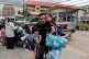 A man carries schoolgirls outside the site of a school shooting in Thailand's Nonthaburi province, August 7, 2026