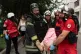 Rescuers evacuate an injured civilian after a residential building was hit following Russia's drone attack in Kharkiv, Ukraine