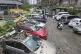 Residents pass by vehicles damaged by a fallen wall in the aftermath of Typhoon Dolphin in Wenzhou in eastern China's Zhejiang province, August 10, 2026