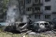 Rescue workers try to put out a fire of a residential building and cars burning after a Russian air guided bomb strike in Zaporizhzhia, Ukraine, August 10, 2026