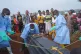 People dressed in protective gear lower into a grave the coffin containing the remains of Jeannine Katusabe, who died of Ebola, during a burial service in Bunia, Ituri province, eastern Congo, August 11, 2026