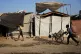 A Palestinian child pushes a wheelchair carrying empty water jerrycans at a camp for displaced people in Gaza City, August 13, 2026