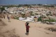 Displaced Palestinian Children carry food portions in Deir al-Balah, central Gaza Strip, August 14, 2026