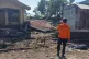 A rescuer inspects earthquake damage at a neighborhood in Mbay, Nagekeo regency, East Nusa Tenggara Province, Indonesia, August 16, 2026