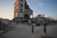 Children walk amid the ruins of buildings destroyed by Israeli airstrikes during the war with Hamas, in Gaza City, August 17, 2026