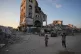 Children walk amid the ruins of buildings destroyed by Israeli airstrikes during the war with Hamas, in Gaza City, August 17, 2026