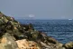 Cargo ships are seen at sea in the Gulf of Oman near the Strait of Hormuz, from a rocky shoreline near Khor Fakkan, United Arab Emirates