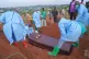 People dressed in protective gear lower into a grave the coffin containing the remains of 6-year-old Baudjo Baraka Jules, who died of Ebola, in Bunia, Ituri province, eastern Congo, August 18, 2026