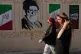 Women walk past a portrait of the late Iranian Supreme Leader Ayatollah Ali Khamenei, who was killed in the US and Israel strike on February 28, 2026