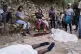People gather next to the bodies of people they said were their relatives and were killed in a gang attack in the Kenscoff neighborhood of Port-au-Prince, Haiti,