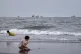 Children play at a beach as commercial vessels are anchored in the Strait of Hormuz off Bandar Abbas, Iran, August 26, 2026