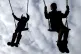 Children enjoy playing on swings in a park near Ashford, Kent