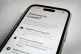 A mobile phone displays the welcome screen to the ChatGPT app