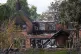 Firefighters looking at the burnt out remains of a house following a huge blaze in Stourbridge, in the West Midlands, which forced some people to flee after it started tearing through homes
