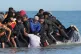 A group of people thought to be migrants board a dinghy near the beach at Gravelines, France, June 17, 2025