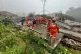 In this photo released by Xinhua News Agency, rescuers conduct a rescue operation at the site of a mudslide following days of heavy rain from tropical cyclone Saudel in Suichuan County of Ji'an City