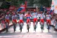 Spain's Enric Mas, center, flanked by his teammates, celebrates as he crosses the finish line after winning the overall classification of the Spanish Vuelta cycling race in Granada, Spain, September 13, 2026